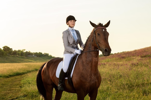 Equestrian sport. Young woman riding horse on dressage advanced test