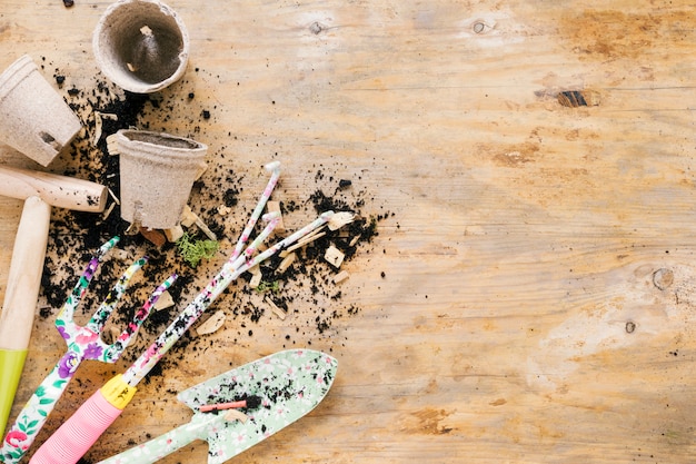 Free photo equipments of gardening and soil with blank peat pot on table