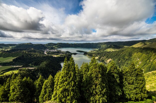 Establishing shot of the Lagoa das Sete Cidades lake taken from Vista do Rei in the island of Sao Miguel, The Azores, Portugal. The Azores are a hidden gem holiday destination in Europe.
