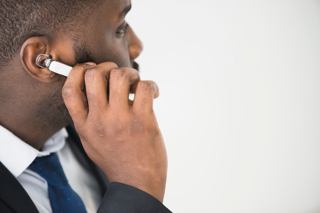 Ethnic businessman adjusting headset