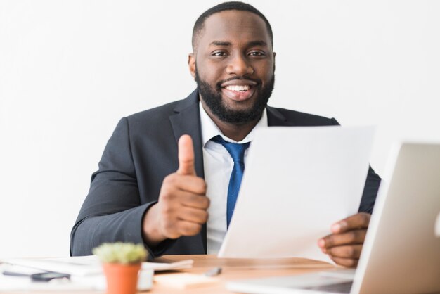 Ethnic businessman gesturing thumb up