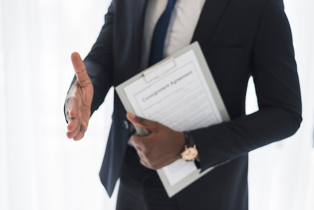 Ethnic businessman giving hand for shake