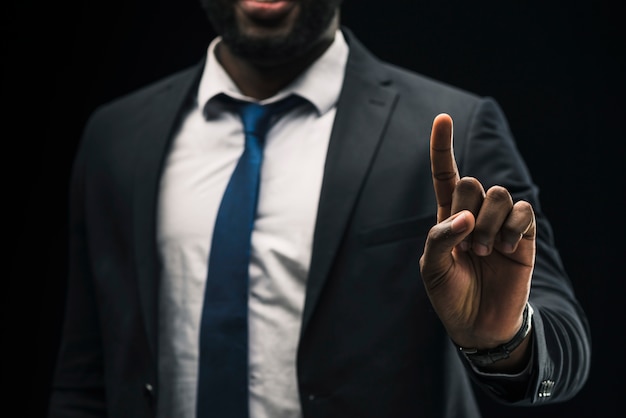 Ethnic businessman pointing up