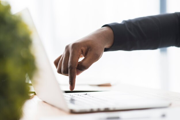 Ethnic businessman pressing button