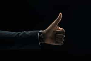 Free photo ethnic businessman showing thumb up