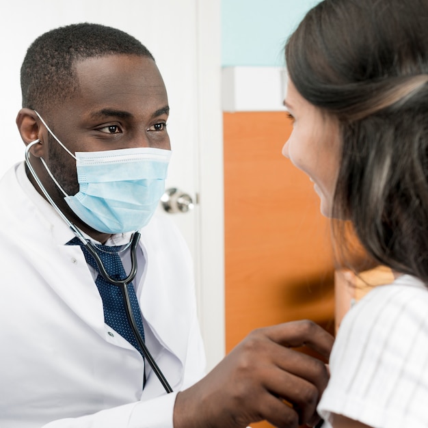 Ethnic doctor working with patient