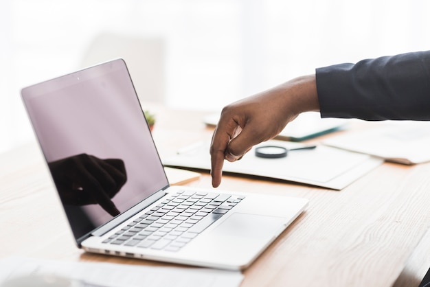 Free photo ethnic employee pressing button