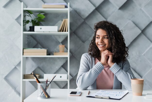 Ethnic employee sitting at workplace in office