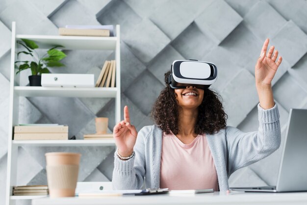 Ethnic female employee testing VR glasses