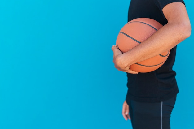 Ethnic man holding basketball