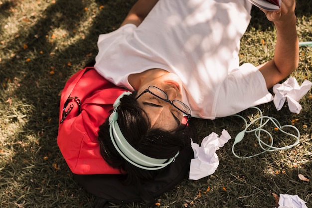 Ethnic teen laying on ground