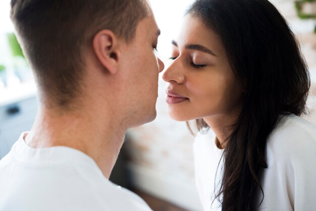 Ethnic woman going to kiss boyfriend