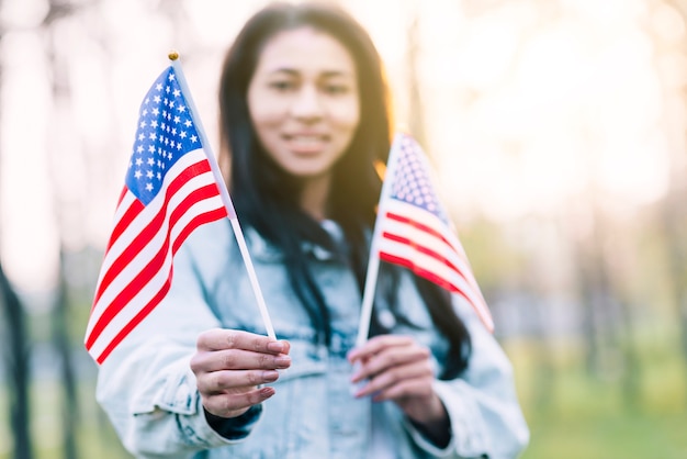 Ethnic woman holding souvenir American flags