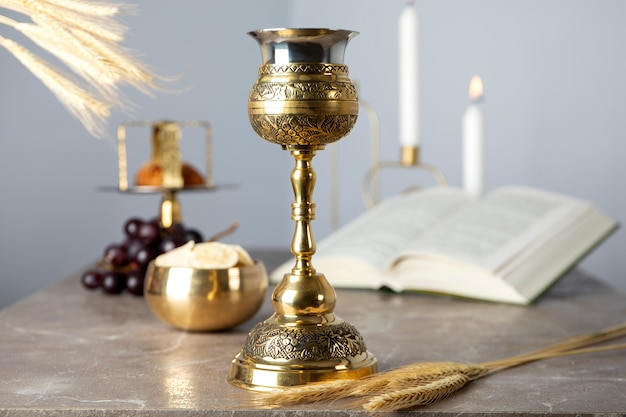 Free photo eucharist celebration with chalice and book