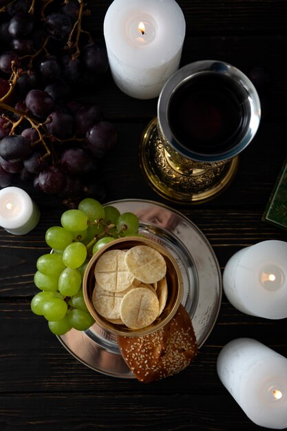 Eucharist with wine chalice and grapes top view