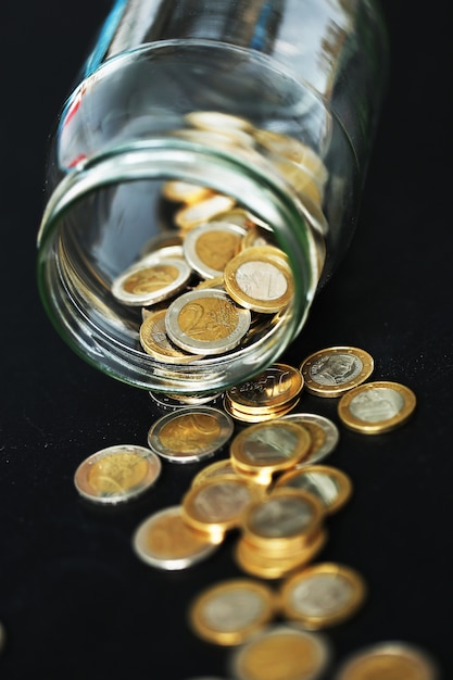 Euro coins in a glass jar