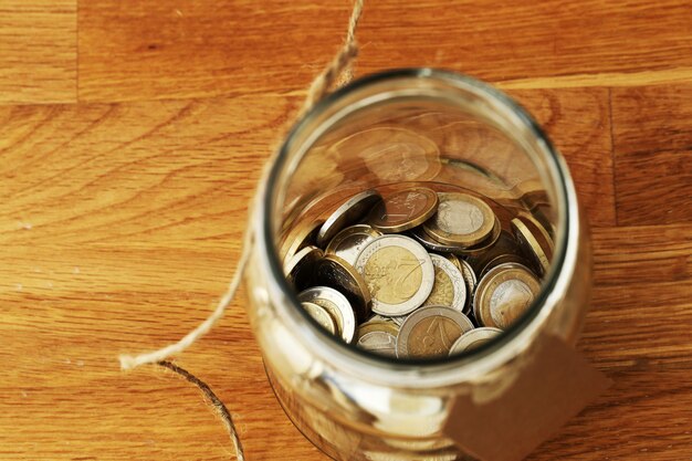 euro coins in a glass jar