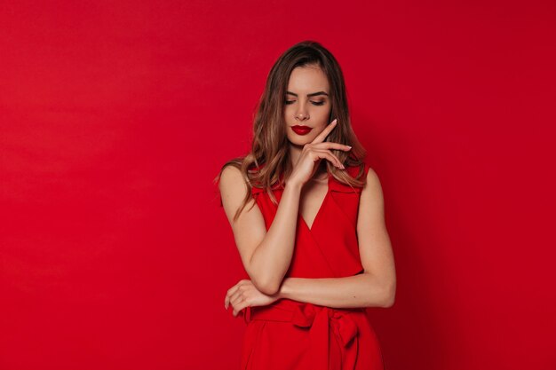 European lady in red dress with red lipstick closed eyes and and on, Valentine's day, holiday, birthday