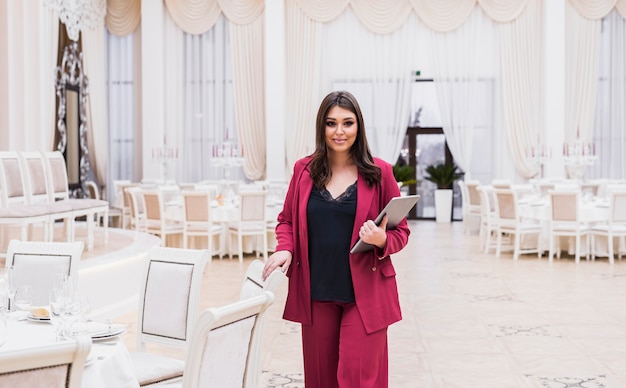 Event manager with laptop in banquet hall