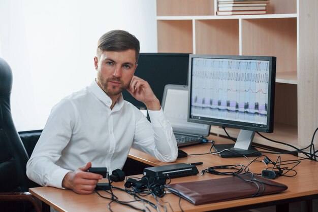 Everybody lies. Polygraph examiner works in the office with his equipment