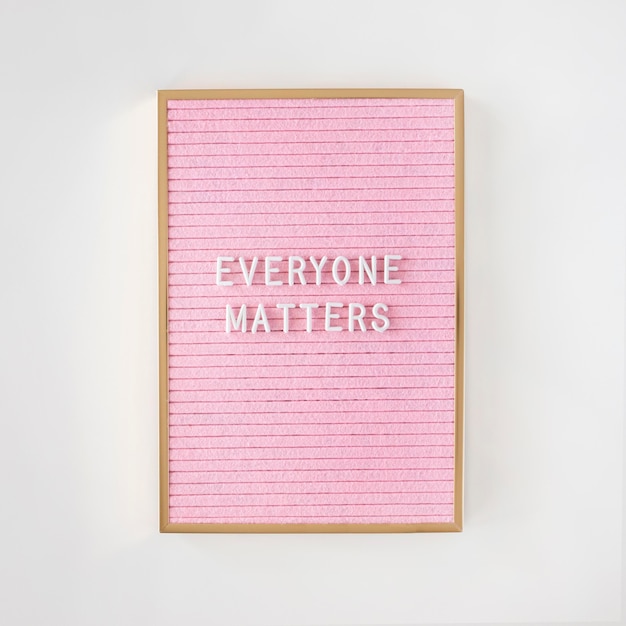 Free photo everyone matters quote on a pink fabric