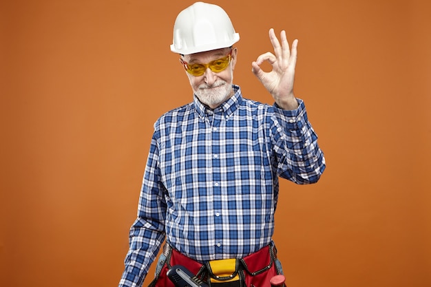 Everything is under control. Portrait of eldelry mature Caucasian handyman with thick beard