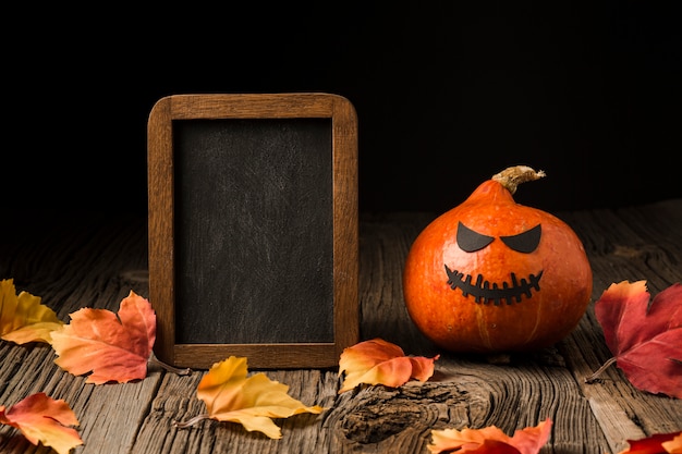 Evil halloween pumpkin surrounded by leaves