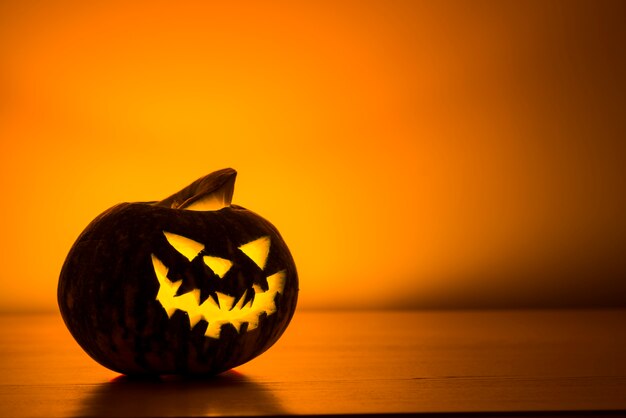 Evil opened jack-o-lantern with candle