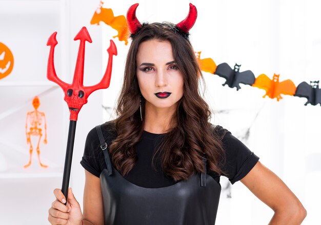 Evil woman holding trident for halloween