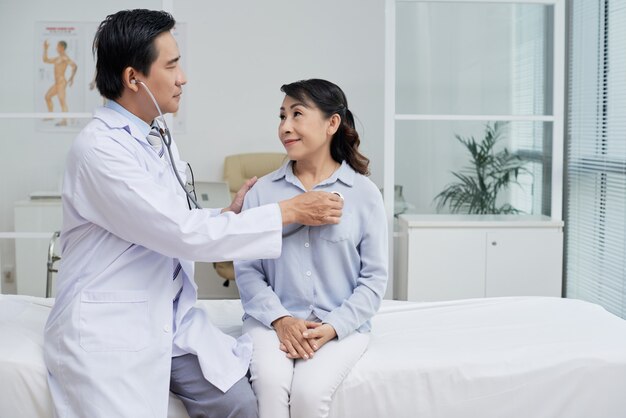 Examining Senior Patient with Stethoscope