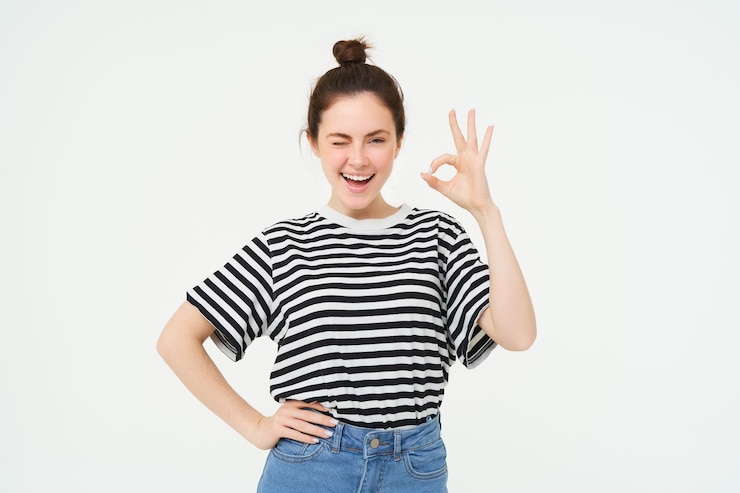 Free Photo excellent choice smiling stylish young woman showing okay ok gesture zero sign standing over white