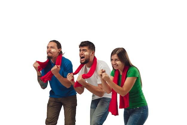 Excellent goal. Three soccer fans woman and men cheering for favorite sport team with bright emotions isolated on white studio background.