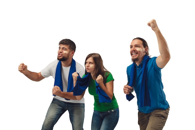 Excellent goal. Three soccer fans woman and men cheering for favorite sport team with bright emotions isolated on white studio background.