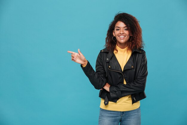 Excited amazing young african woman standing isolated