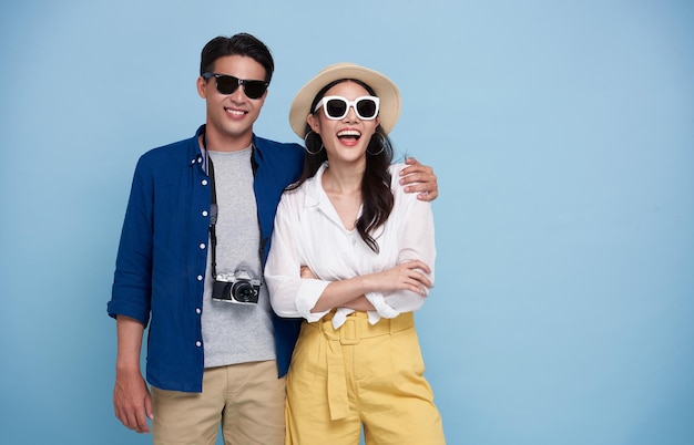 Excited Asian couple tourist dressed in summer clothes to travel on holidays