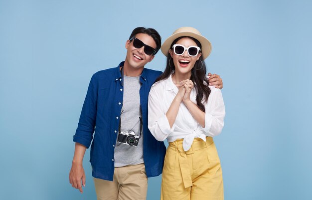 Excited Asian couple tourist dressed in summer clothes to travel on holidays