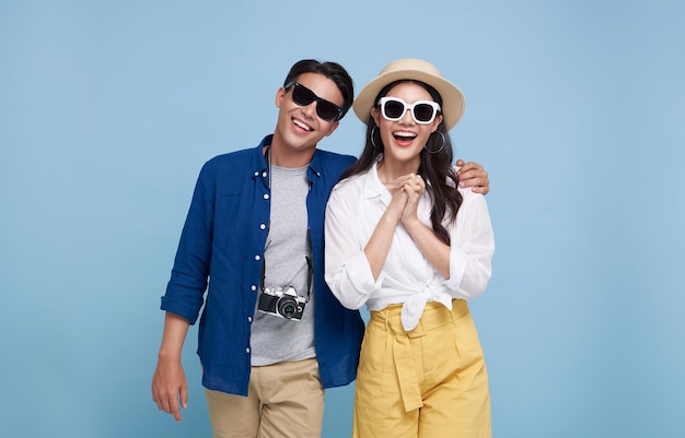 Excited Asian couple tourist dressed in summer clothes to travel on holidays