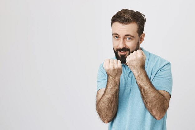 Excited bearded guy want to fight, smiling
