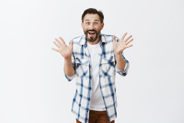 Excited bearded mature man posing