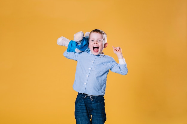 Free photo excited boy with teddy bear