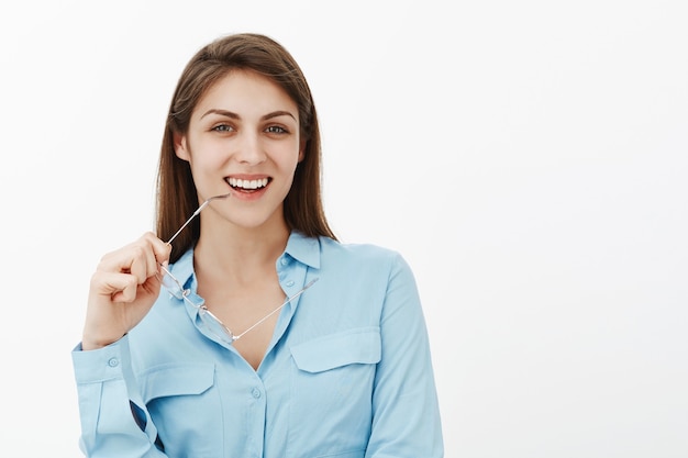 Excited brunette businesswoman posing in the studio