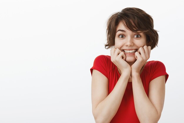 Excited cheerful woman hear amazing news, looking upbeat