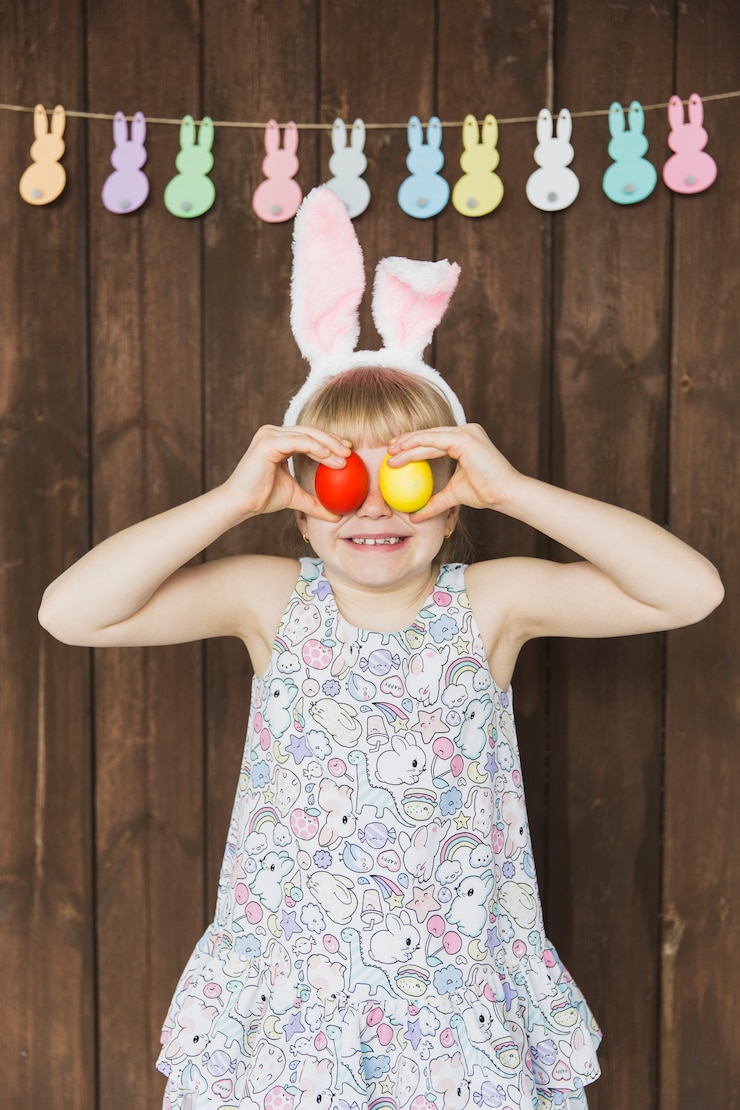 Free Photo excited child covering eyes with easter eggs