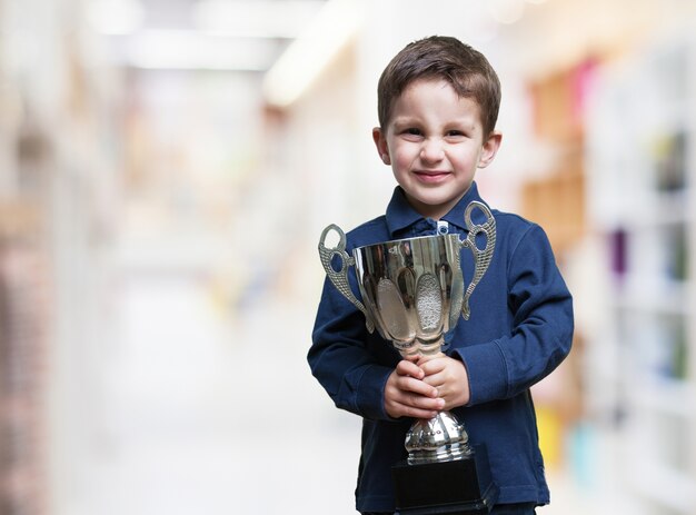 Excited child holding a trophy