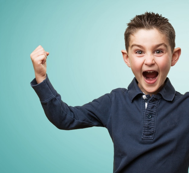 Free photo excited child with fist up