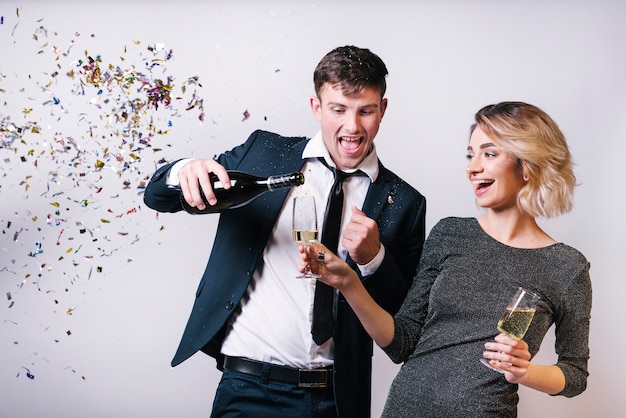 Excited couple enjoying champagne