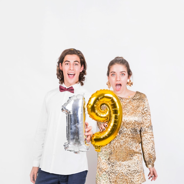 Excited couple holding balloons 19