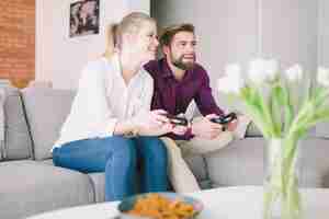 Free photo excited couple with gamepads