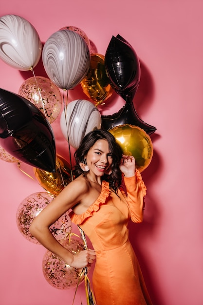 Excited dark-haired woman enjoying party shooting