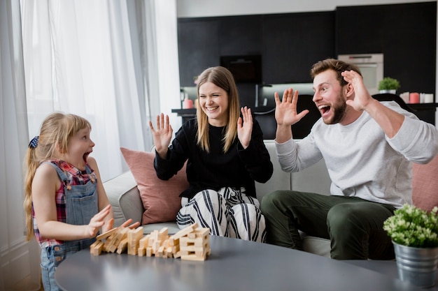 Excited family playing jenga